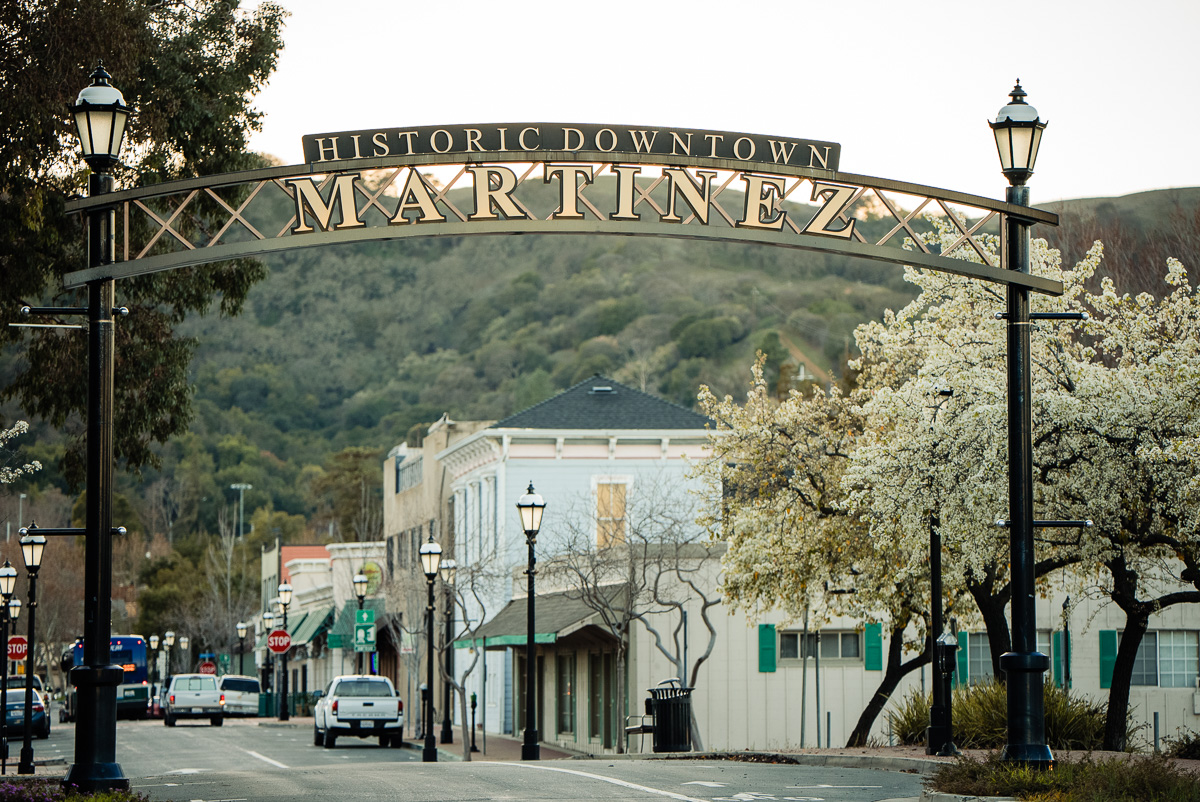 Historic downtown Martinez sign with buildings in view